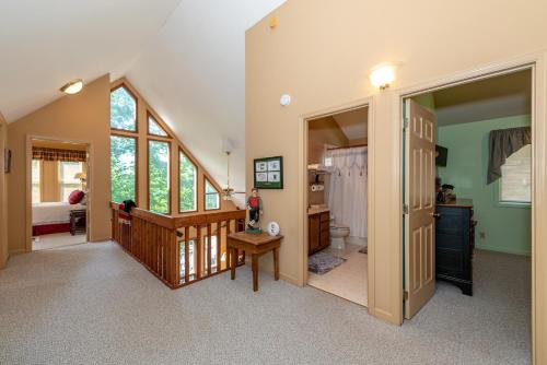 a large room with a staircase and a bathroom at Laurel Lodge At Last in Townsend