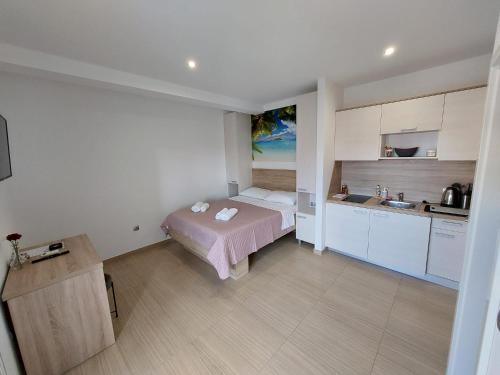 Kleines Zimmer mit einem Bett und einer Küche in der Unterkunft Apartmani Tropical in Vodice