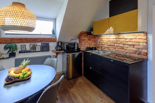 a kitchen with a table with a bowl of fruit on it at ABC apartments in Kamnik