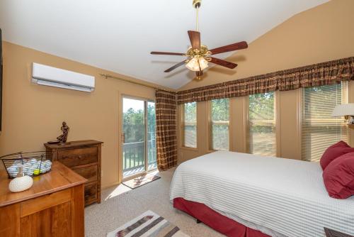 a bedroom with a bed and a ceiling fan at Laurel Lodge At Last in Townsend