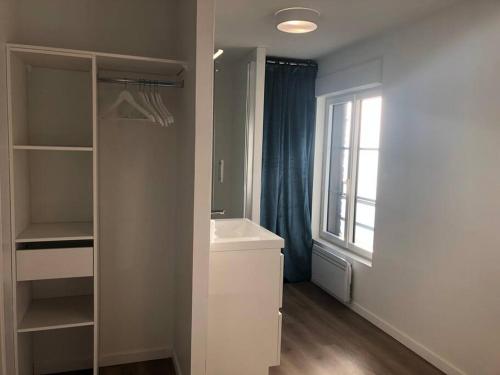 a white bathroom with a sink and a window at Maison Gabriel Appartement BULLE in Abbeville