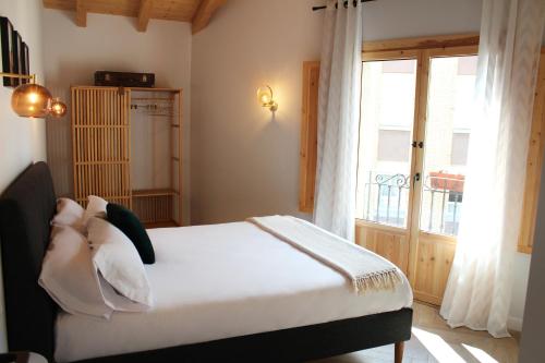 a bedroom with a bed and a large window at XIMENETXE Vivienda Turística in Santa Cruz de Campezo