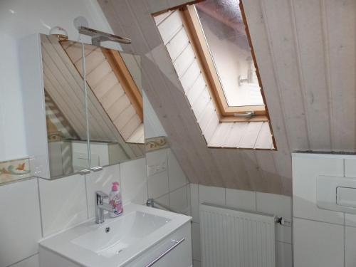 a bathroom with a sink and a skylight at Ferienwohnung in Porta Westfalica