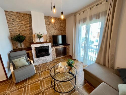 a living room with a couch and a fireplace at Villa Rangel in Olivenza