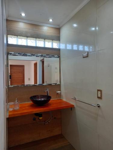 a bathroom with a sink and a mirror at Sueños de Montaña in Villa Yacanto
