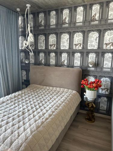 a bedroom with a bed and a wall of windows at J. Ralio apartamentai (monkey) in Vilnius