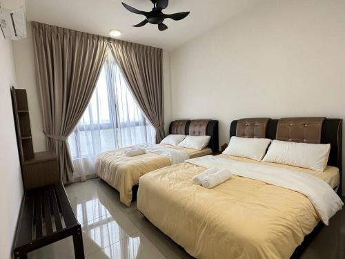 a bedroom with two beds and a ceiling fan at Bali Residence Melaka near Jonker Street in Melaka