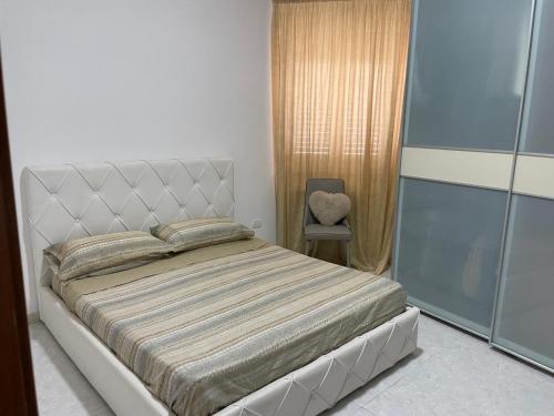 a bedroom with a bed and a chair at B&B Casa Mimì in San Ferdinando di Puglia