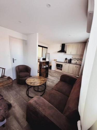 a living room with a couch and a table at Studio tout confort in Blaye-les-Mines