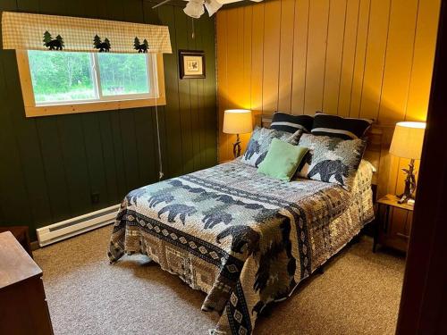 a bedroom with a bed and a window at The Lakeside Eagle's Nest Near the Trail in Hurley