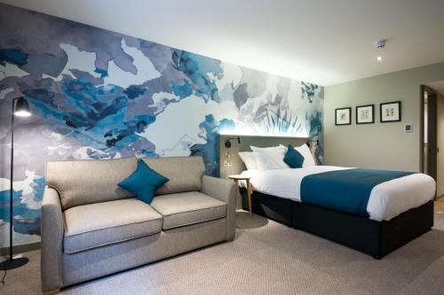 a bedroom with a bed and a couch at The Melville Inn by Innkeeper's Collection in Dalkeith