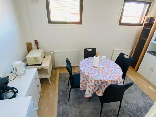 a room with a table and chairs with a table and a table and a table at two bedrooms,dining area and bathroom with private entrance in Kotka