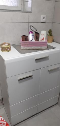 a white kitchen counter with a pink tray on it at Tića3 in Laćarak