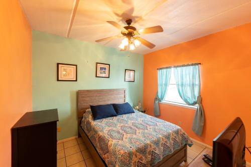 a bedroom with a bed and a ceiling fan at South Padre Island condo is walking distance to the beach, Sleeps 6, Third Floor, 2024 Traveler Award in South Padre Island