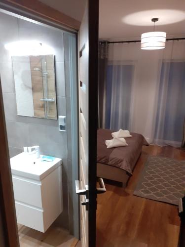 a small room with a bed and a bathroom at VILLA EDEN USTKA wypoczynek dla dorosłych in Ustka