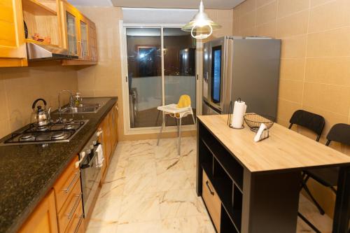 a kitchen with a counter top and a refrigerator at AeroChic in Nouaceur