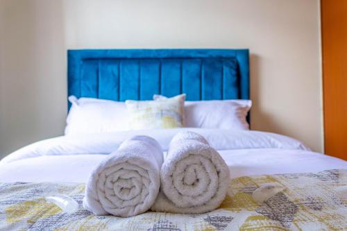 a pair of towels sitting on top of a bed at Quzuri Homestay nearJKIA SGR NRB Kenya in Syokimau