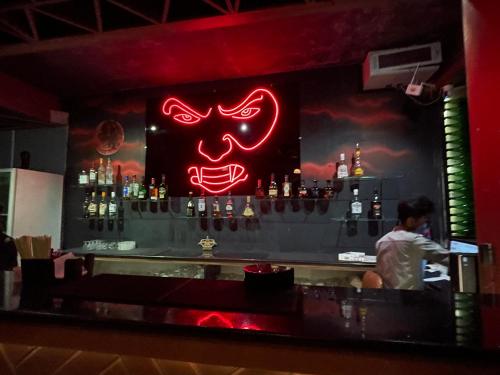 a bar with a red neon mask on the wall at NT Hotels and Resorts Akridha in Puducherry