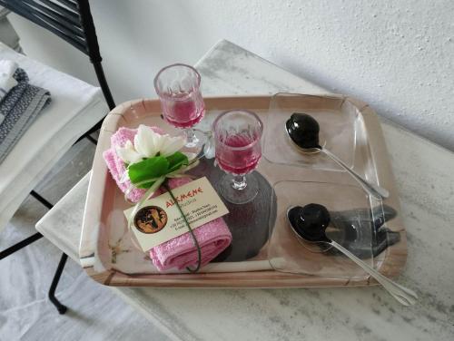 a tray with two glasses and flowers on a table at ALKMENE STUDIOS in Skiathos