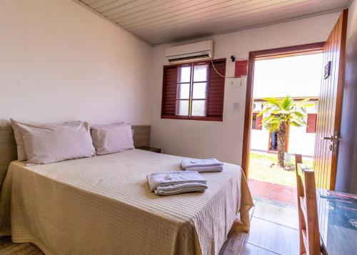 Tempat tidur dalam kamar di Hotel Alegrete