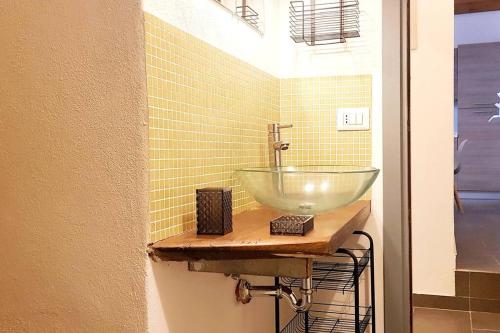 a bathroom with a glass bowl sink on a counter at L'Artista in Trecastagni