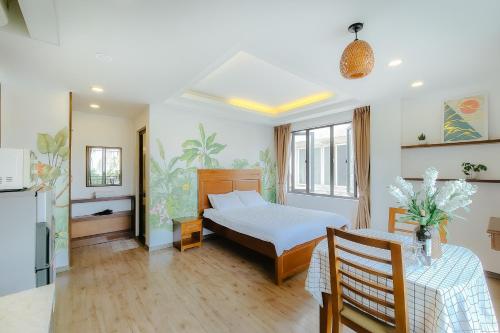 a bedroom with a bed and a table in it at LUCK APART 03 - Tay ho Center Garden View Studio! in Hanoi