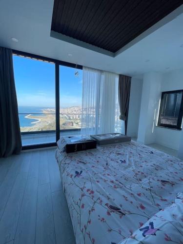 a bedroom with a bed with a view of the ocean at Luxury Triplex Villa in Trabzon