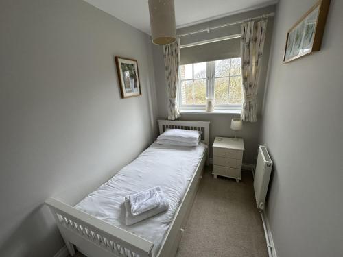 a small bedroom with a bed and a window at Newt's Place in Filey
