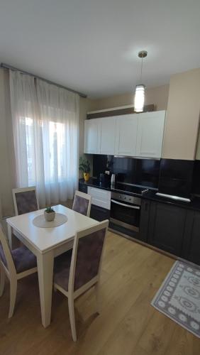 a kitchen with a table and chairs in a room at Tirana New Bazaar-Apartment 1 in Tirana
