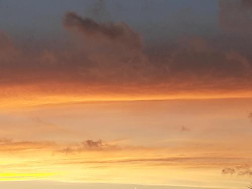 a painting of a cloudy sky at sunset at Il Tuffatore B&B in Capaccio-Paestum