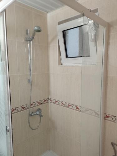 a bathroom with a shower with a television in it at Splendid studio apartment in Bečići