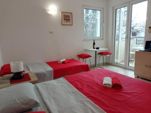a hotel room with two beds and a table and chairs at Splendid studio apartment in Bečići