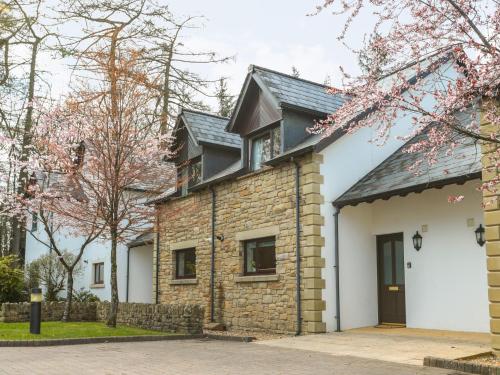 a brick house with a black roof at Honeybee Cottage in Penrith