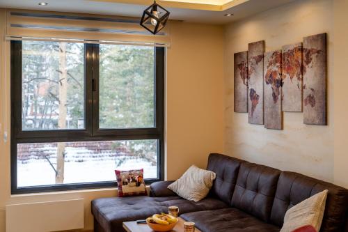 a living room with a couch and a window at Apartman DanKa in Zlatibor