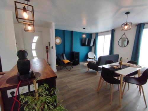 a living room with a table and a dining room at Ma maison de vacances en Bretagne in Meillac