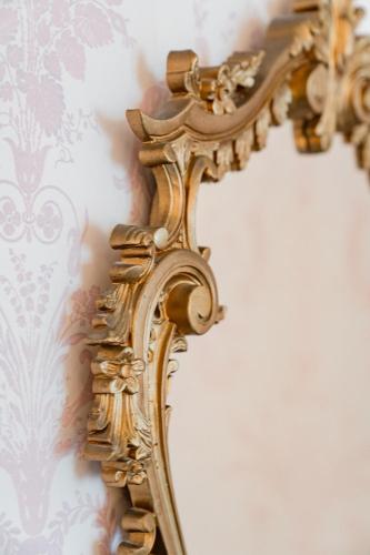 a gold mirror hanging on a wall at Lee House in Lynton
