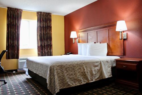 A bed or beds in a room at HomeTown Inn & Suites