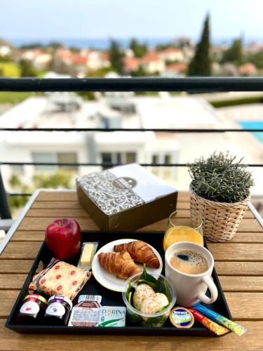 a tray of breakfast food and coffee on a table at Pissouri Image in Pissouri