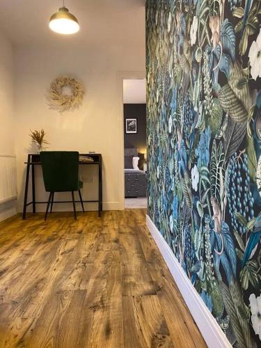 a room with a painting on the wall with a chair at Luxury Riverfront Apartment in Newport