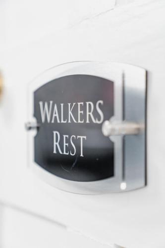 a sign that reads walkers rest hanging on a wall at Lee House in Lynton