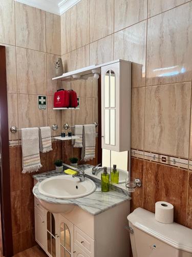 a bathroom with a sink and a mirror at Slice of ponta do sol Room 1 in Ponta do Sol