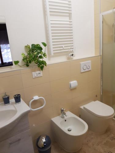 a bathroom with a toilet and a sink at B&B da Natallia in Ronco allʼAdige