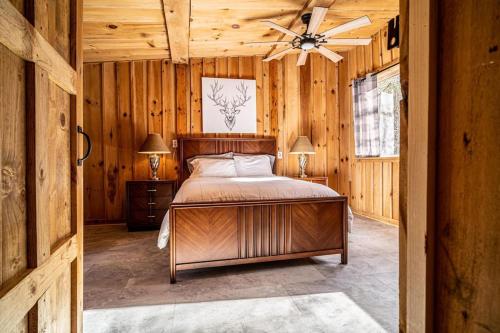 a bedroom with a bed and a ceiling fan at Hike the Holler - Stay & Explore in Cosby