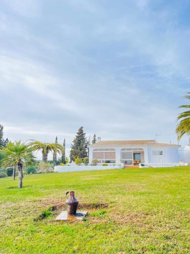 a house with a yard with a fire hydrant in the grass at Villa Serro das Vinhas in Portimão