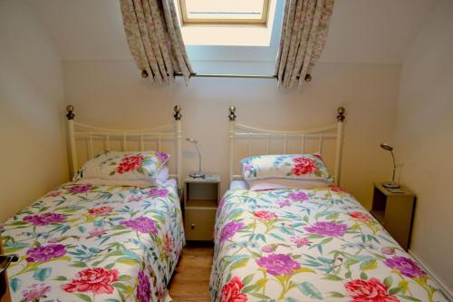 two beds sitting next to each other in a bedroom at Holiday home in Falcarragh, Gortahork, Donegal in Falcarragh