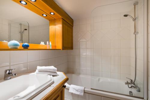 uma casa de banho com uma banheira e um lavatório em Lagrange Vacances Le Cristal d'Argentière em Chamonix-Mont-Blanc