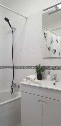 a white bathroom with a shower and a sink at Casa da Conceição - Bay View Spot in Funchal
