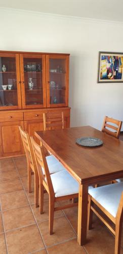 a wooden dining room table with chairs and cabinets at Casa da Conceição - Bay View Spot in Funchal