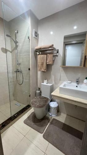 a bathroom with a shower and a toilet and a sink at APPARTEMENT de LUXE au COEUR de Oujda - City Budget Coralia in Oujda