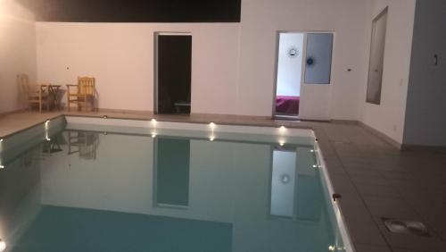 a swimming pool in a room with a table and chairs at Lemon tree in Tías